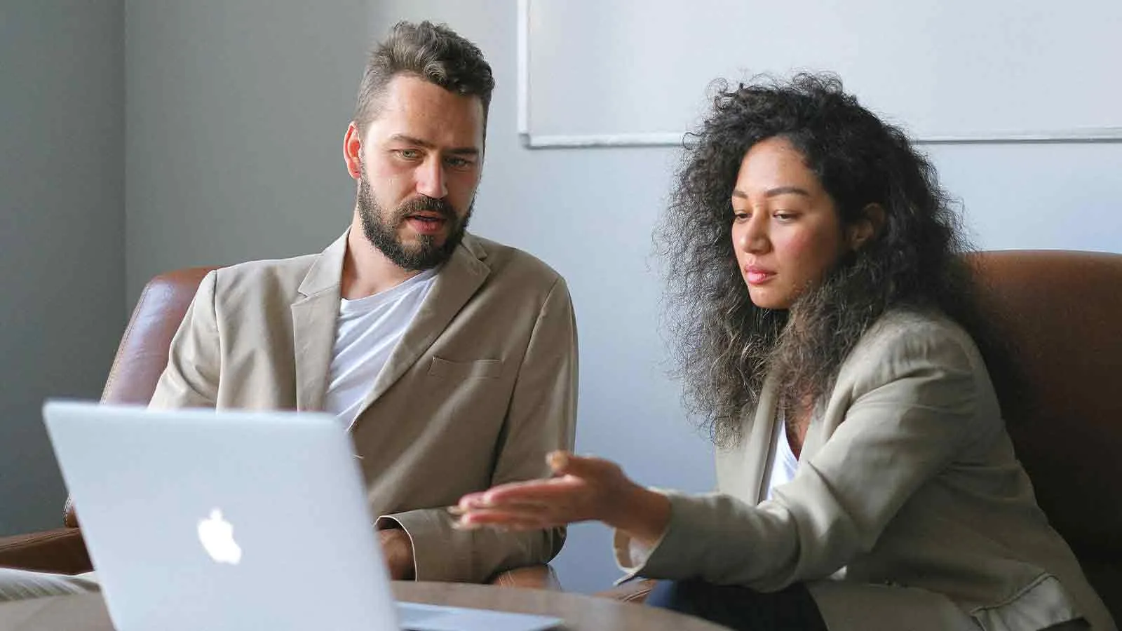 Attorney reviewing a title defect finding on a laptop with a client